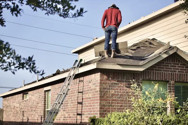 Professional roofer working on a residential roof in Buckholts